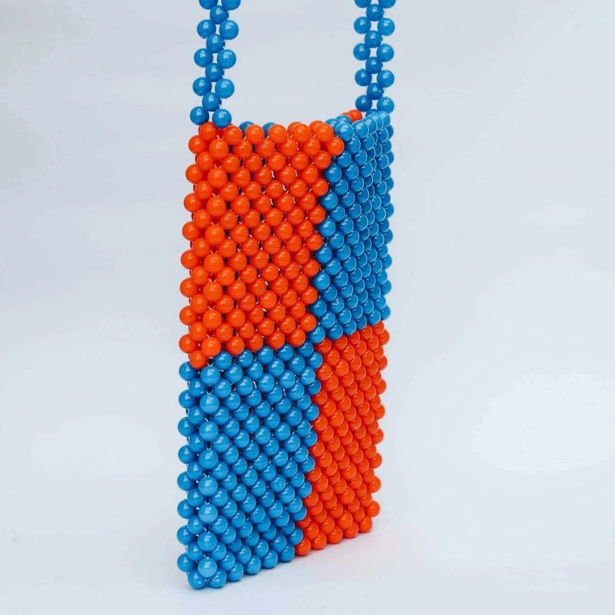 Blue and orange beaded bag with a chain on a light gray background
