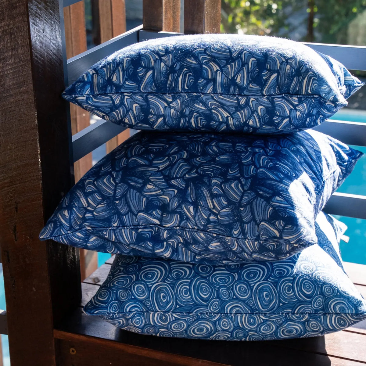 Stack of Stack of Pacific outdoor cushions showing Pipi, Growth Rings and Shells prints.Pacific outdoor cushions showing Pipi, Growth Rings and Shells prints.