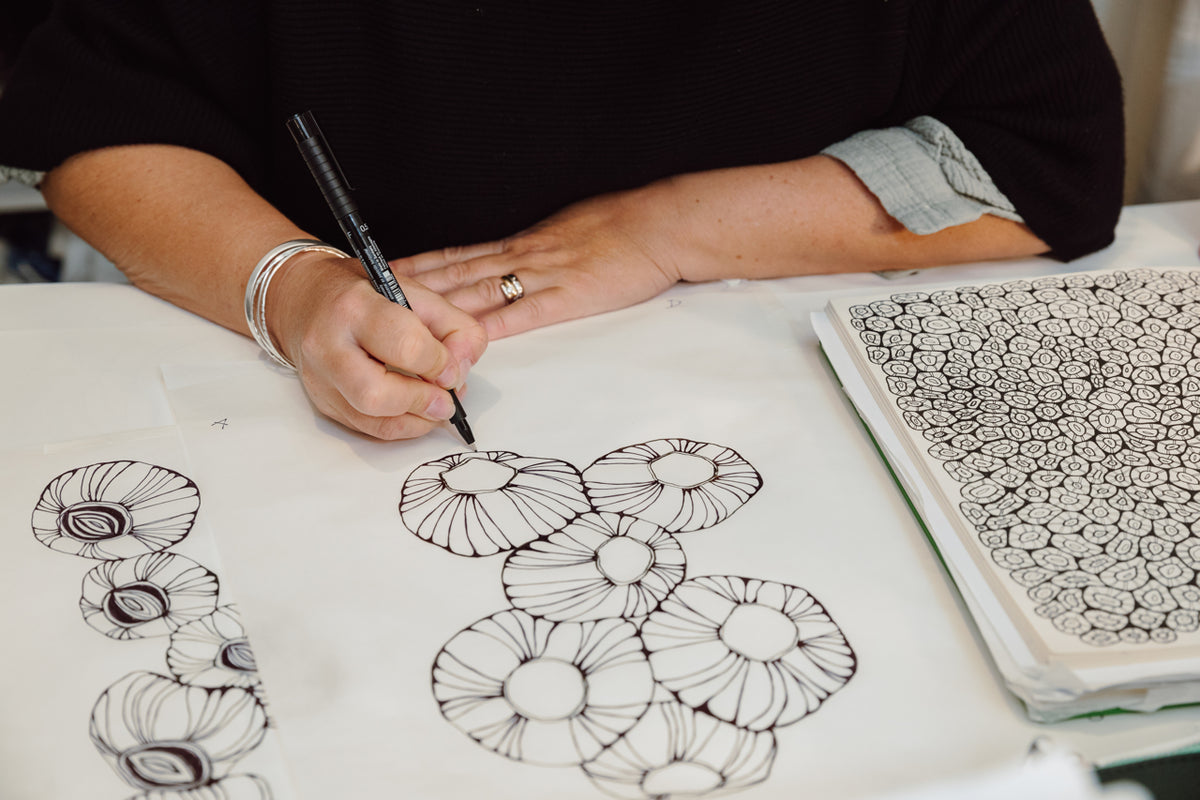 Jess Scott hand-drawing a coastal pattern in pen