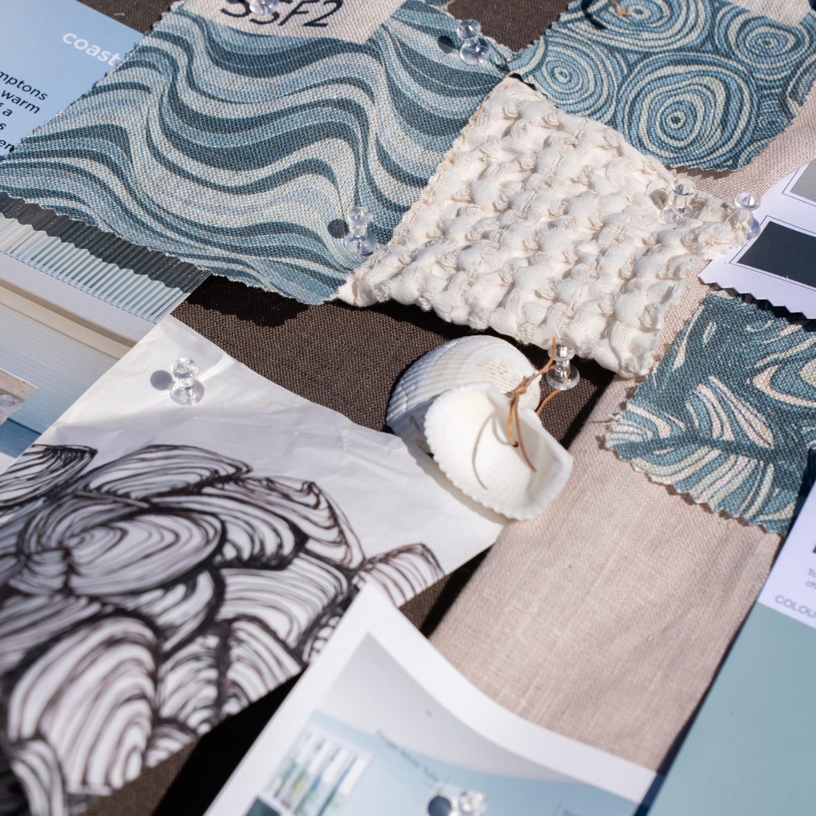 Detailed close-up of the Frenchmans Shells design mood board with fabric swatches, shells and design references.