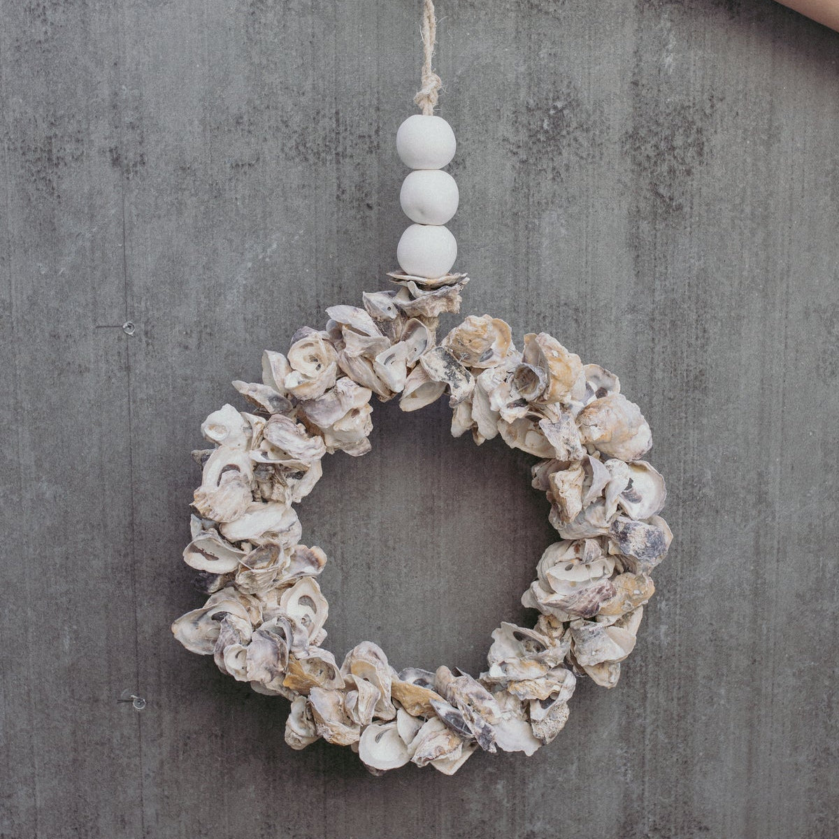 Handcrafted oyster shell wreath in white, pearl, soft purple and burnt orange with ceramic beads
