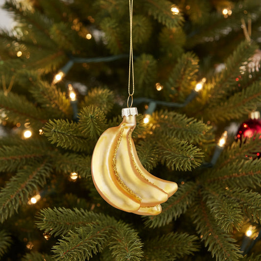 Glass bananas Christmas ornament hanging on a Christmas tree