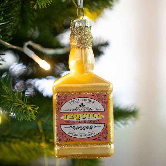 Glass tequila bottle Christmas ornament hanging on a Christmas tree