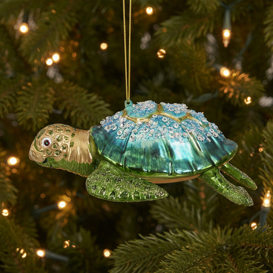 Glass turtle Christmas decoration hanging on a Christmas tree