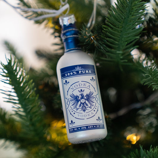 Glass vodka bottle Christmas ornament hanging on a Christmas tree