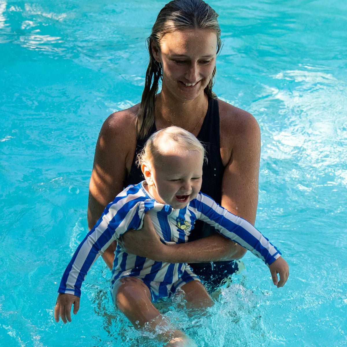 Mother and toddler in a swimming pool, part of the Starfish Studio Frenchman lifestyle series (no cushion shown in this image)