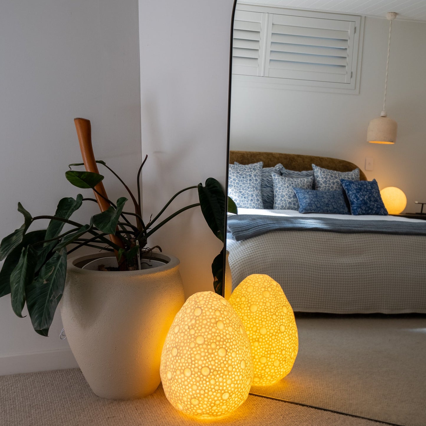 Handcrafted dotted oval reef lamp glowing with warm ambient light