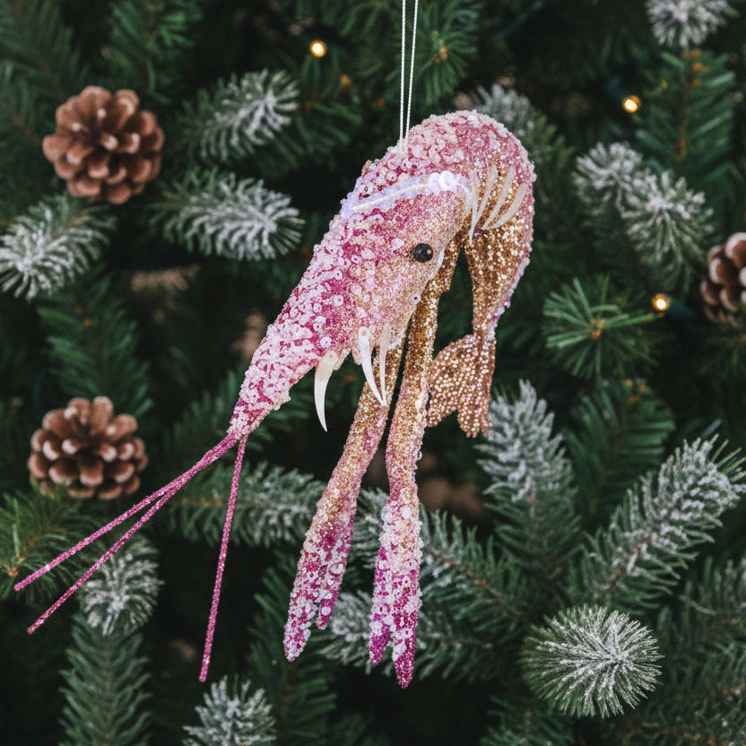 Pink glitter prawn Christmas decoration hanging on a Christmas tree