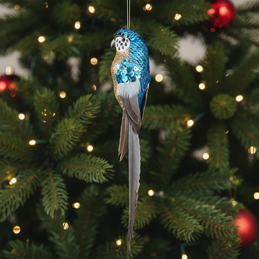Sequinned blue budgie Christmas decoration hanging on a Christmas tree